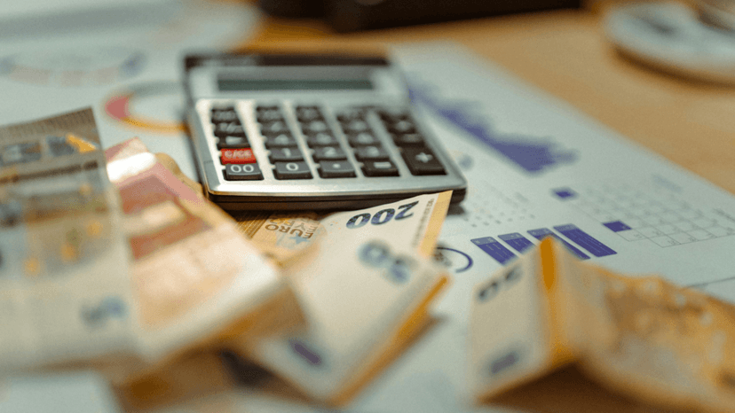 Calculator resting on paperwork showing accumulating tax penalties