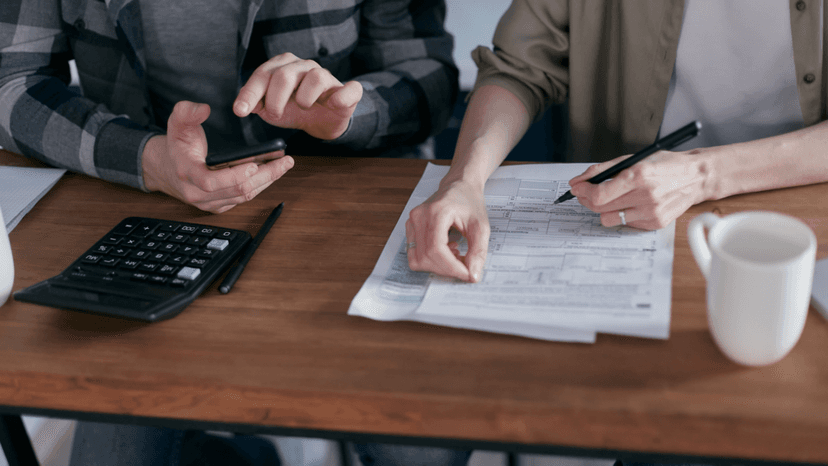 Couple reviewing property tax forms with a calculator