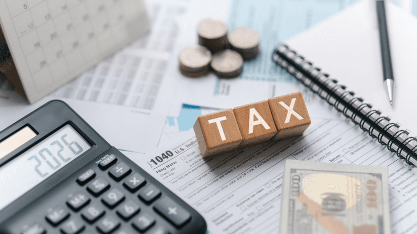 Desk setup showing tax calculation tools and financial documents