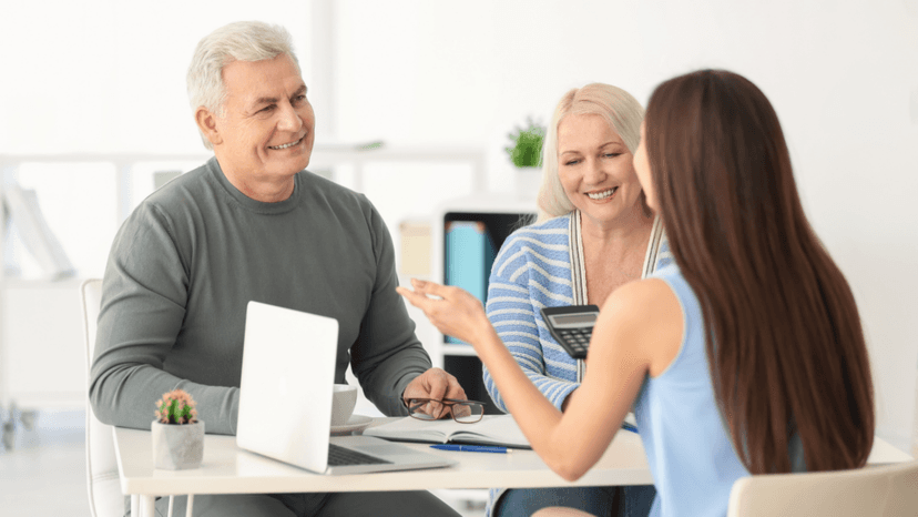 Elderly couple learning about local property tax freeze benefits