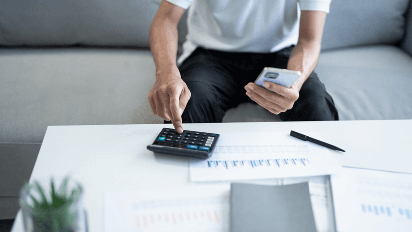 Homeowner reviewing Texas property tax rates with calculator and phone