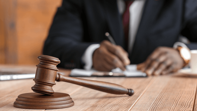 Legal professional writing notes for a property tax appeal hearing