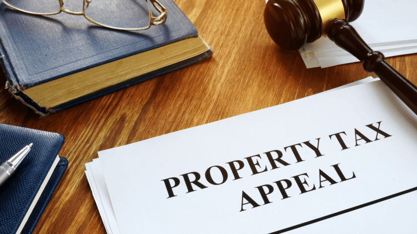 Property tax appeal documents and gavel on a wooden desk