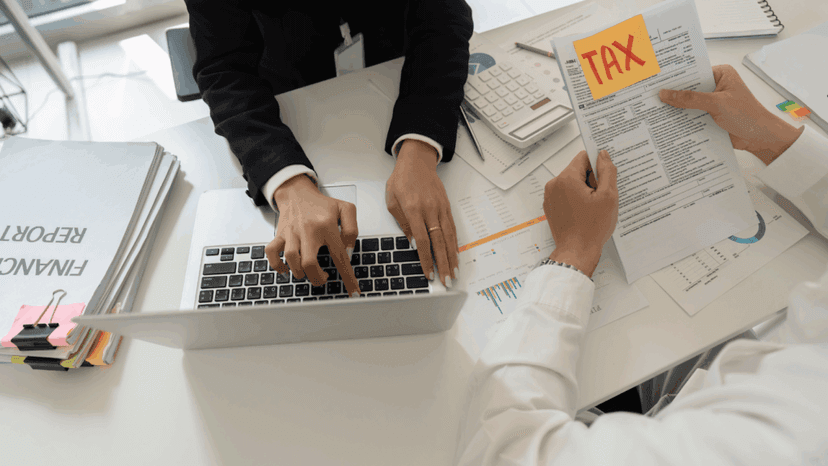 Tax consultant assisting client with financial reports and tax documents