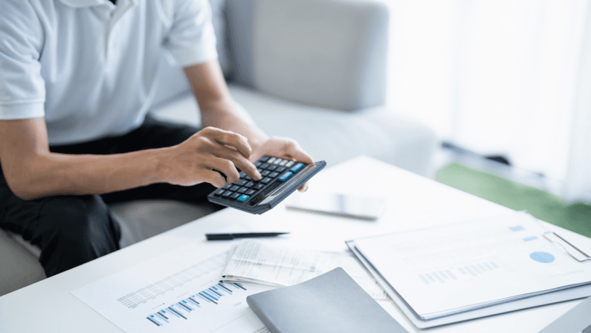 Consultant computing property tax reduction using charts and financial records