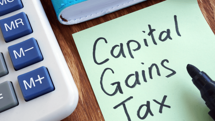 Capital gains tax note beside calculator representing inherited property tax obligations