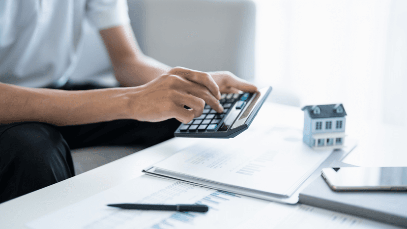 Calculator and property documents used in cost approach appraisal assessment