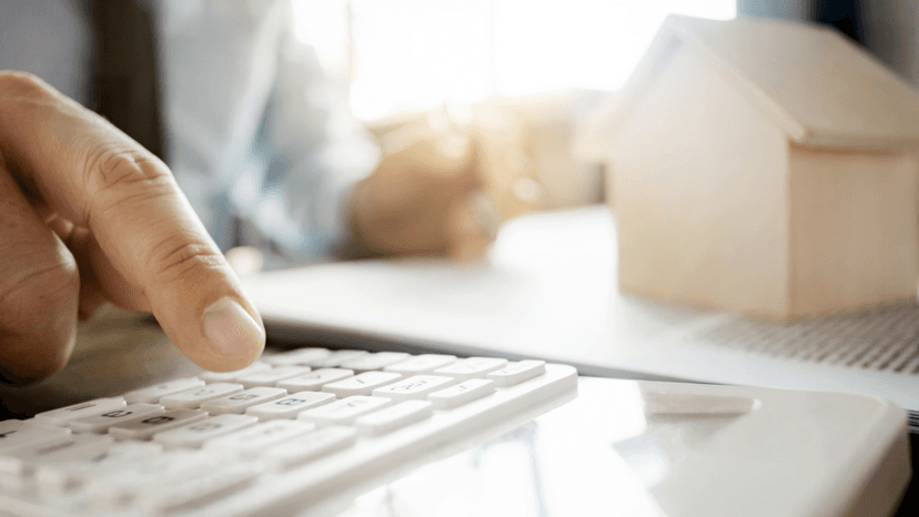 Consultant using calculator to determine correct property tax appraisal method