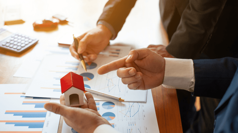 Consultants reviewing property valuation charts that misrepresent comparable home sales data