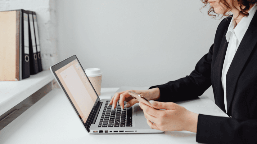 Homeowner following up with appraisal district using laptop and mobile phone