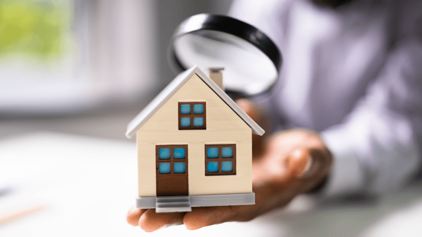Magnified view of a house model illustrating property value distinctions