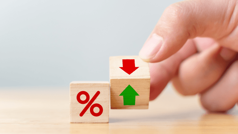 Percentage symbol and arrows on blocks representing cap rate valuation changes