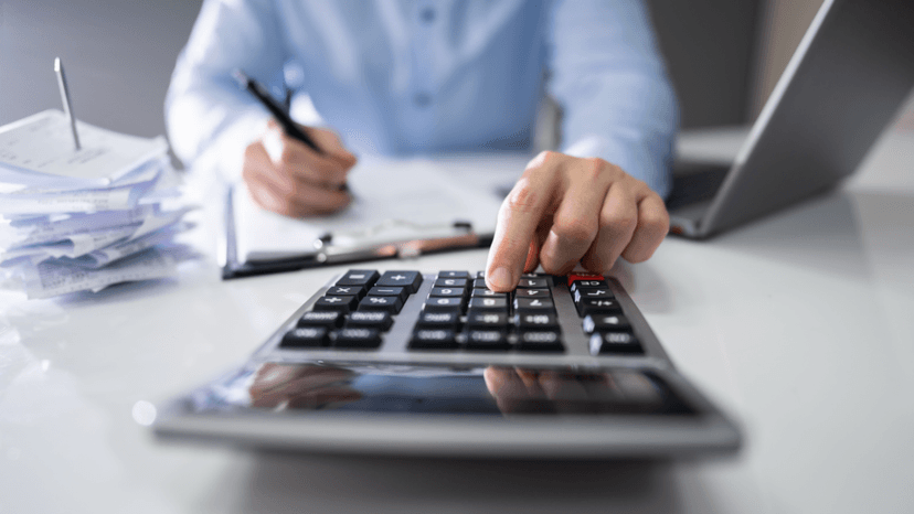 Professional reviewing accumulated tax documents and calculating long term property tax impact
