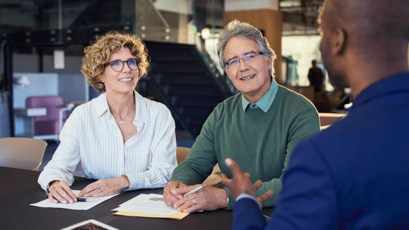 Senior homeowners in discussion with tax consultant about exemption benefits
