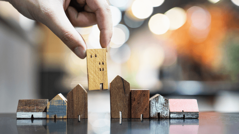 Wooden house models of varying sizes highlighting unequal property appraisal comparisons