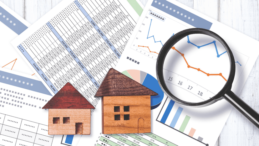 Wooden house models on financial spreadsheets illustrating income approach appraisal